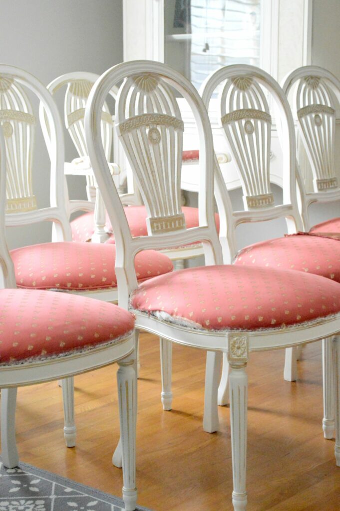 Vintage Balloon Back Dining Room chairs with Gold Gilding wax over antique white paint at www.thepainteddrawer.com